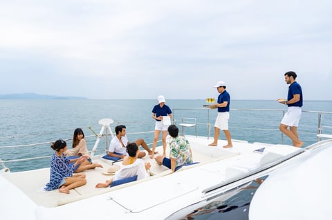 Yacht crew serving champagne