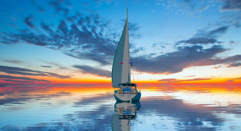 Yacht sailing in Mediterranean sea at amazing sunset