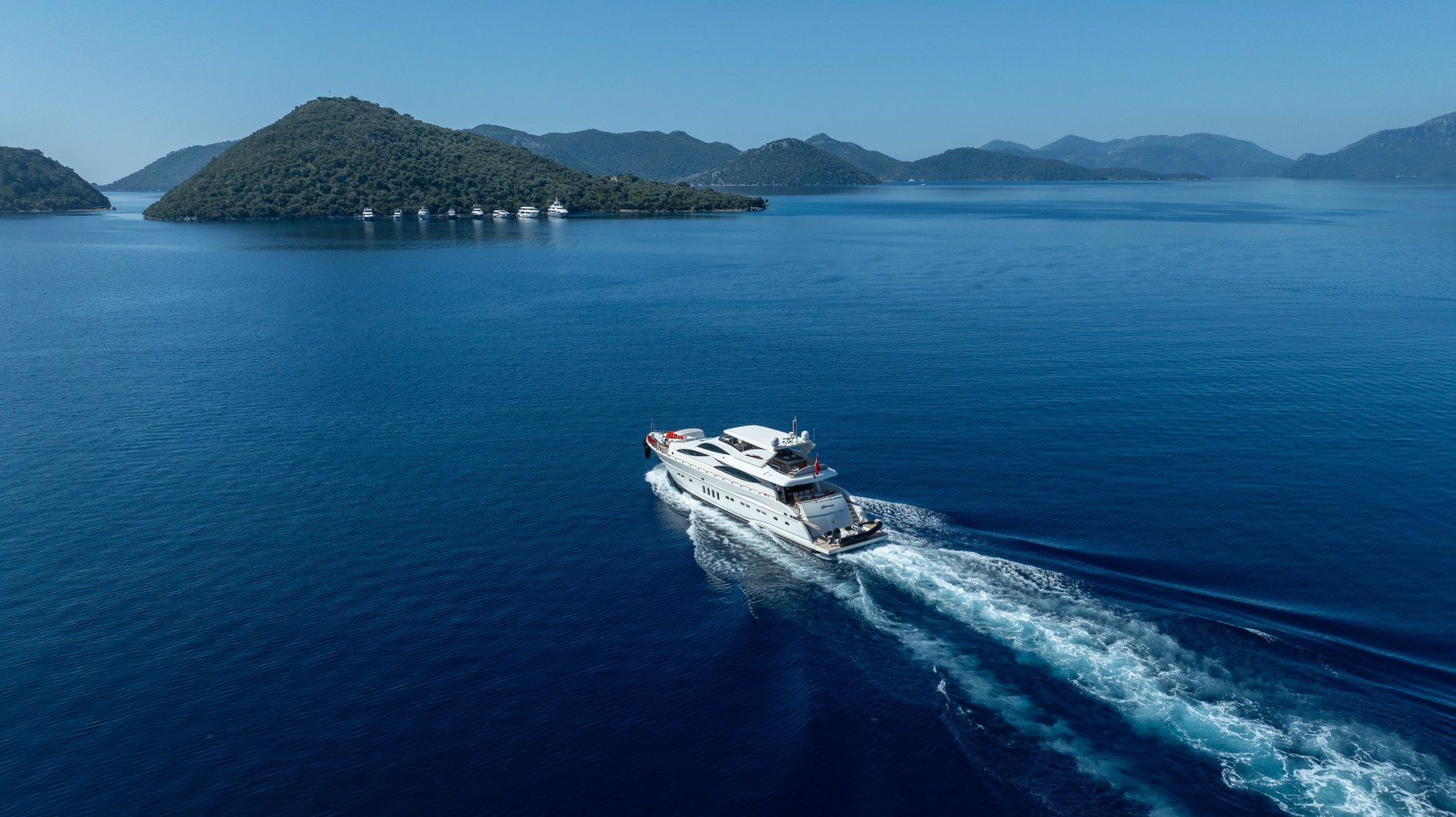 Premium white yacht cruising across deep blue waters