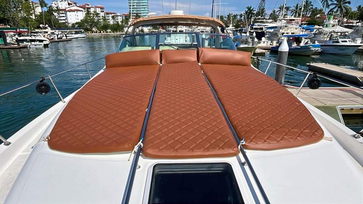 Sea Ray 51 Ft luxury speedboat with rust-colored sunpad in marina
