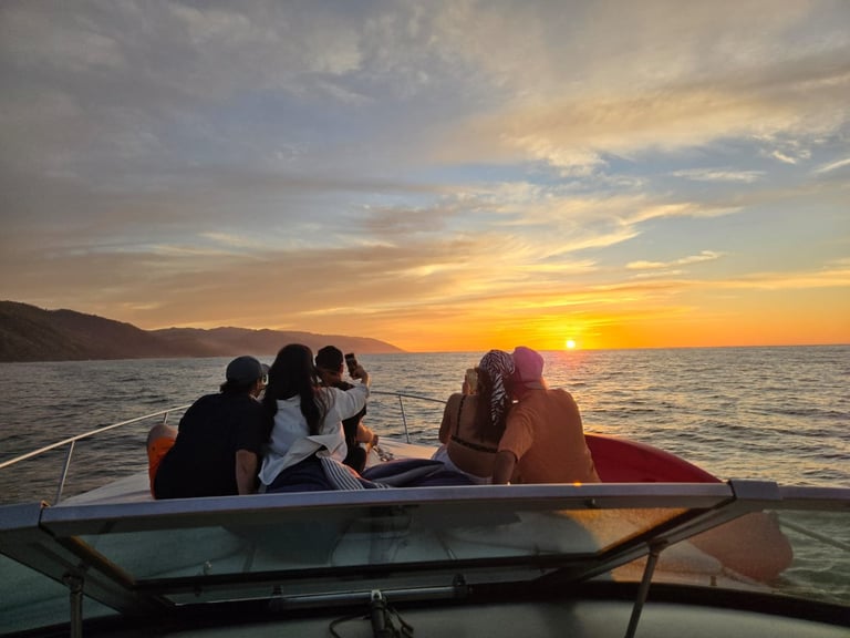 Golden sunset over ocean with boat silhouette